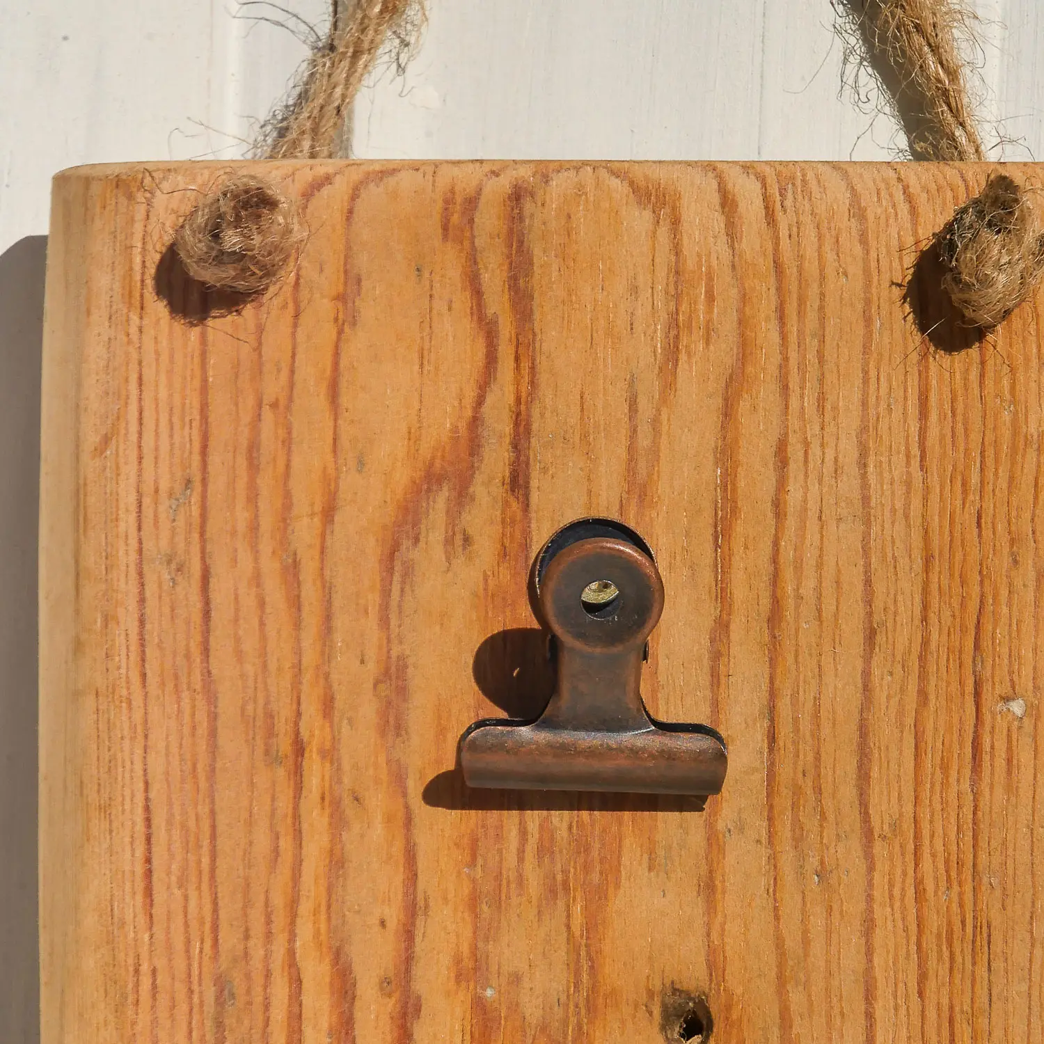 Aufnahme eines handgearbeiteten Wand-Notizhalters aus recyceltem Altholz im skandinavischen Stil. Holzmaserung ist sichbat und Befestigungsclip für Notizen ist vorhanden. Nachhaltig & handgefertig.
